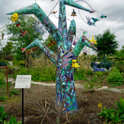 Tree of Life, 2021. Tree: enamel paint on metal and stucco, 96 x 66 x 66 inches; individual sculptures: glazed ceramic, 12 x 12 x 12 inches.